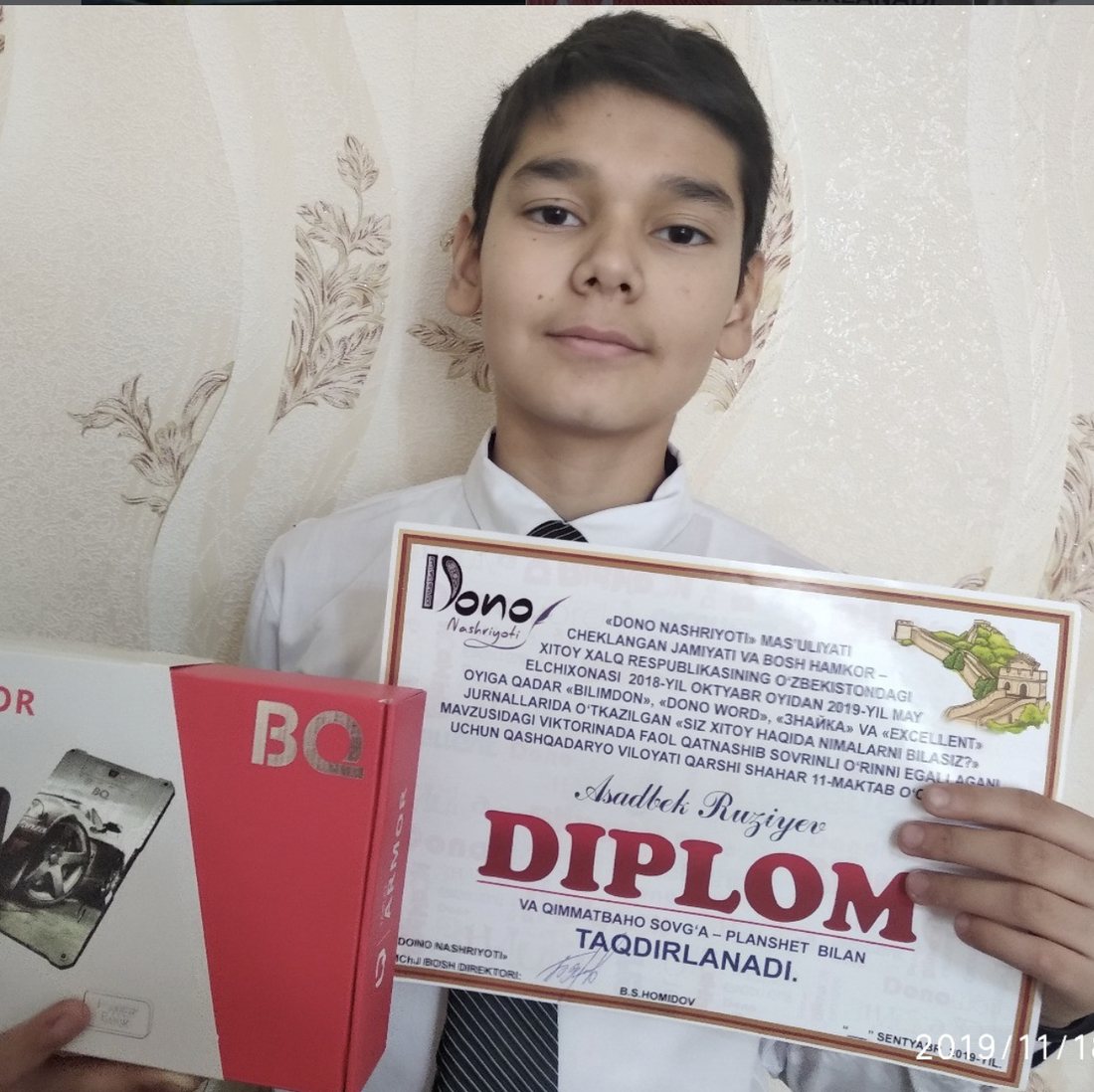 Asadbek at 13 with the Dono Nashriyoti diploma and tablet prize