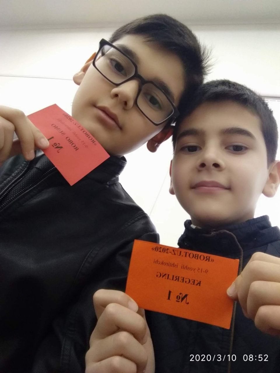 Asadbek and his brother with Robot-UZ 2020 participant cards